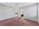 Primary bedroom with carpeted floors leads to an attached bathroom and features sliding door patio access at 2094 Mesic Hammock Way, Venice, FL 34292
