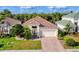 Aesthetic aerial shot showcasing a home with manicured lawn, red brick driveway, and tropical vegetation at 2094 Mesic Hammock Way, Venice, FL 34292