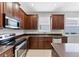 This modern kitchen boasts stainless steel appliances, abundant storage, and tile floors at 2094 Mesic Hammock Way, Venice, FL 34292
