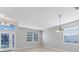 Bright living room with neutral walls, tile flooring, and large windows for ample natural light at 2094 Mesic Hammock Way, Venice, FL 34292