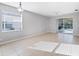 Open concept living room features tile flooring, large windows, and a view of the backyard pool at 2094 Mesic Hammock Way, Venice, FL 34292