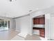 The bright living room offers tile floors, sliding glass doors, and a built-in desk and shelving at 2094 Mesic Hammock Way, Venice, FL 34292