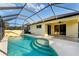Inviting screened-in pool area featuring clear blue water, a sun deck, and views of the backyard at 2094 Mesic Hammock Way, Venice, FL 34292