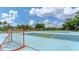 Outdoor sport court with hockey net, basketball hoops, benches, and play area in the background at 2094 Mesic Hammock Way, Venice, FL 34292
