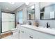 Stylish bathroom with a double vanity, modern fixtures, and a glass-enclosed shower at 23 Tiffany St, Englewood, FL 34223