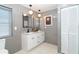 Elegant bathroom featuring a double vanity, modern lighting, and a neutral color palette at 23 Tiffany St, Englewood, FL 34223