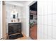 Chic bathroom with an updated vanity, round mirror, and a view to a bricked patio at 23 Tiffany St, Englewood, FL 34223