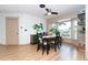 Bright dining room featuring a bay window, wood floors, and stylish decor at 23 Tiffany St, Englewood, FL 34223