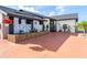 Stylish home showcasing a patterned privacy wall, mature landscaping, and a bright red driveway at 23 Tiffany St, Englewood, FL 34223