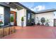 Stylish home featuring mature landscaping and a bright red driveway with an inviting front entrance at 23 Tiffany St, Englewood, FL 34223