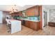Stunning kitchen with wooden cabinets, stone countertops, and stainless-steel appliances at 23 Tiffany St, Englewood, FL 34223