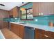 Modern kitchen featuring wood cabinets, sleek countertops, and stainless steel appliances for the home chef at 23 Tiffany St, Englewood, FL 34223