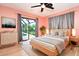Serene main bedroom with hardwood floors, soft colors, and a view of the pool at 23 Tiffany St, Englewood, FL 34223