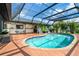 This backyard boasts a screened-in pool and a brick paver patio at 23 Tiffany St, Englewood, FL 34223