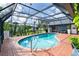 Enclosed pool area featuring a brick patio and a screened enclosure, perfect for year-round enjoyment at 23 Tiffany St, Englewood, FL 34223