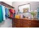 Well-organized walk-in closet with ample storage space and a stylish dresser at 23 Tiffany St, Englewood, FL 34223