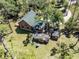 Aerial view of log home on expansive lot with guest house and mature trees at 2450 Flagami Ln, North Port, FL 34286