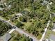Aerial view of a home with mature trees and a circle drive at 2450 Flagami Ln, North Port, FL 34286