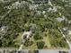 Aerial view of a home surrounded by a natural landscape with mature trees at 2450 Flagami Ln, North Port, FL 34286
