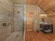 Bathroom boasts a glass-enclosed shower, wood flooring, vanity and sink, providing modern comfort at 2450 Flagami Ln, North Port, FL 34286