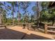 Spacious deck featuring wooden railings and grill overlooking a wooded area, perfect for outdoor relaxation at 2450 Flagami Ln, North Port, FL 34286
