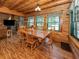 Dining room and living room boasts natural light, wood floors, and a stone fireplace at 2450 Flagami Ln, North Port, FL 34286