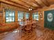 Log cabin dining room with wood floors and multiple windows providing ample natural light at 2450 Flagami Ln, North Port, FL 34286