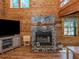 Detailed view of the stone fireplace in a living room with wood paneling at 2450 Flagami Ln, North Port, FL 34286