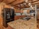 Kitchen featuring granite countertops, stainless steel appliances, and wood floors at 2450 Flagami Ln, North Port, FL 34286
