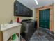 Laundry room with stainless steel appliances, dark cabinets, and a utility sink at 2450 Flagami Ln, North Port, FL 34286