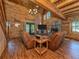 Vaulted living room with wood paneling and stone fireplace at 2450 Flagami Ln, North Port, FL 34286
