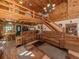 Interior log home boasts an open floor plan with loft, stone fireplace, and wood accents at 2450 Flagami Ln, North Port, FL 34286