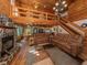 Open-concept log home interior with living room, kitchen, and dining area at 2450 Flagami Ln, North Port, FL 34286