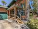 Close-up of the beautiful log home featuring a charming front porch at 2450 Flagami Ln, North Port, FL 34286