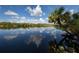 Scenic river view reflecting the blue sky and clouds, showcasing a tranquil waterfront setting at 2450 Flagami Ln, North Port, FL 34286