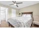 Comfortable bedroom featuring wood floors, ceiling fan and ensuite bathroom at 250 Santa Maria St # 216, Venice, FL 34285