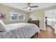 Bedroom with wood floors, dresser, and view to kitchen at 250 Santa Maria St # 216, Venice, FL 34285