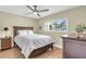 Cozy bedroom with wood-look floors, large window, ceiling fan and stylish furniture at 250 Santa Maria St # 216, Venice, FL 34285