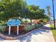 Sign for Centennial Park amidst lush greenery, featuring a fountain and shaded benches at 250 Santa Maria St # 216, Venice, FL 34285