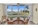 Bright dining area features wicker chairs and views of the harbor at 250 Santa Maria St # 216, Venice, FL 34285