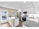 Remodeled kitchen features stainless steel appliances, granite countertops and white cabinets with a breakfast bar at 250 Santa Maria St # 216, Venice, FL 34285