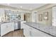 Bright kitchen featuring white cabinets, granite countertops, stainless steel appliances, and an island at 250 Santa Maria St # 216, Venice, FL 34285