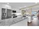 Modern kitchen with granite countertops, stainless steel appliances, and breakfast bar overlooking the dining area at 250 Santa Maria St # 216, Venice, FL 34285