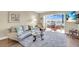 Comfortable living room features a water view, sliding glass doors leading to a sun room and coastal decor at 250 Santa Maria St # 216, Venice, FL 34285