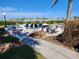 Inviting outdoor patio area with seating, grill, and views of the marina and boats at 250 Santa Maria St # 216, Venice, FL 34285