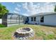 The backyard includes a fire pit and screened-in pool, offering a perfect blend of relaxation and social gatherings at 4068 Palau Dr, Sarasota, FL 34241