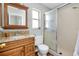 Bathroom features a granite sink, wood vanity, and shower with glass doors at 4068 Palau Dr, Sarasota, FL 34241