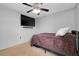 This carpeted bedroom features a ceiling fan and a wall mounted TV at 4068 Palau Dr, Sarasota, FL 34241