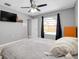 Bright bedroom with a ceiling fan, dark curtains, and a window overlooking the pool area at 4068 Palau Dr, Sarasota, FL 34241