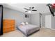Cozy bedroom featuring a ceiling fan, wood dresser, and neutral decor for a relaxing retreat at 4068 Palau Dr, Sarasota, FL 34241
